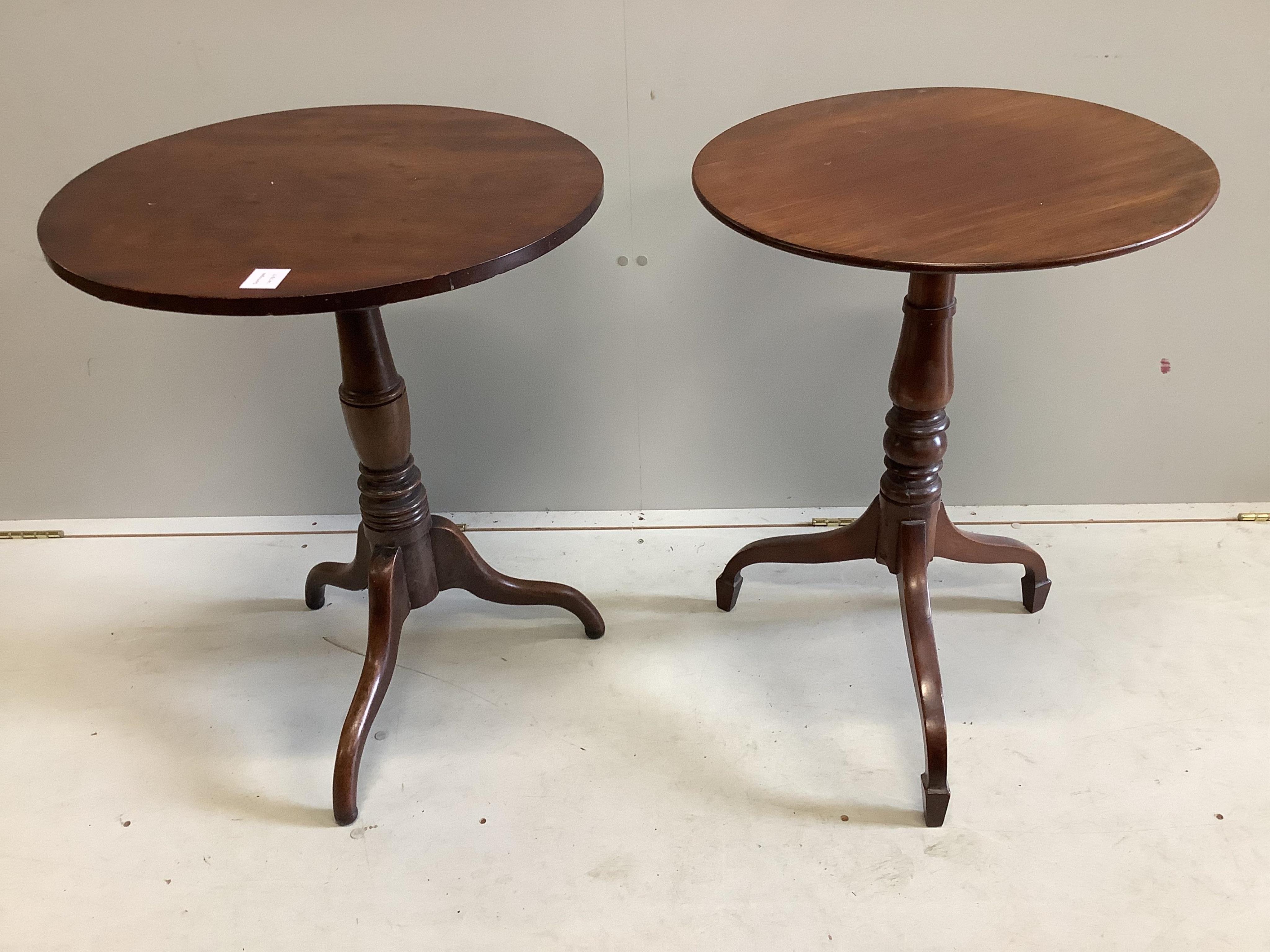 A near pair of Victorian circular mahogany tripod wine tables, larger diameter 57cm, height 71cm. Condition - fair